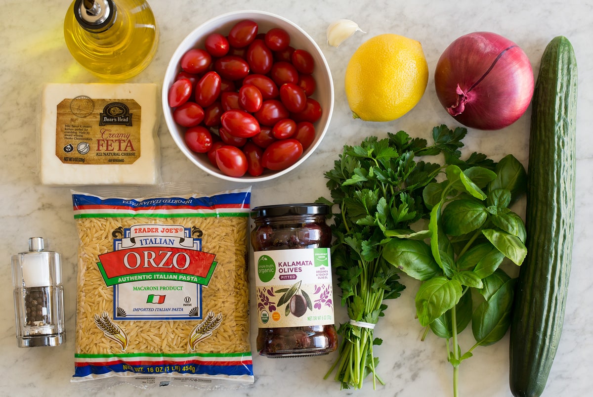 Greek orzo salad dressing and salad ingredients.